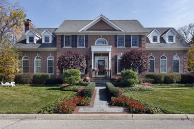 Luxury brick home with columns clipart