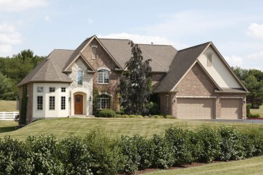 Luxury home with three car garage clipart