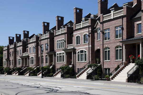 Row of brick townhomes with steps to entry