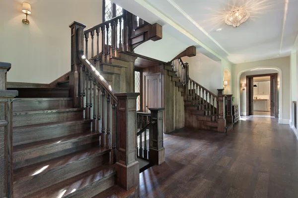 Foyer with dark wood stairway — Stock Photo, Image