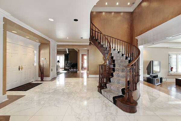 Foyer in luxury home with curved staircase