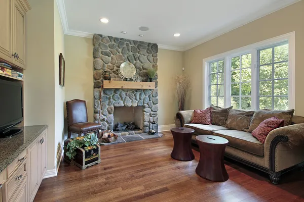Family room with stone fireplace — Stock Photo, Image