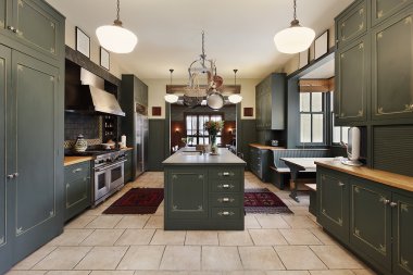 Large kitchen with green cabinetry clipart