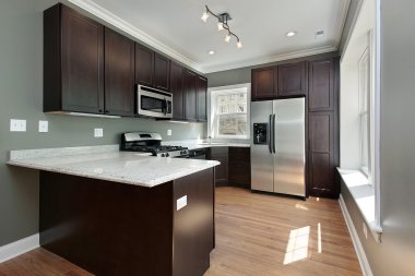 Kitchen with mahogany wood cabinetry clipart