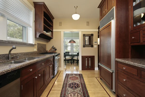 Kitchen with wood paneled refrigerator — Stock Photo, Image