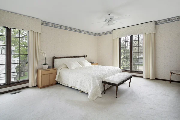 stock image Master bedroom with wood trim windows