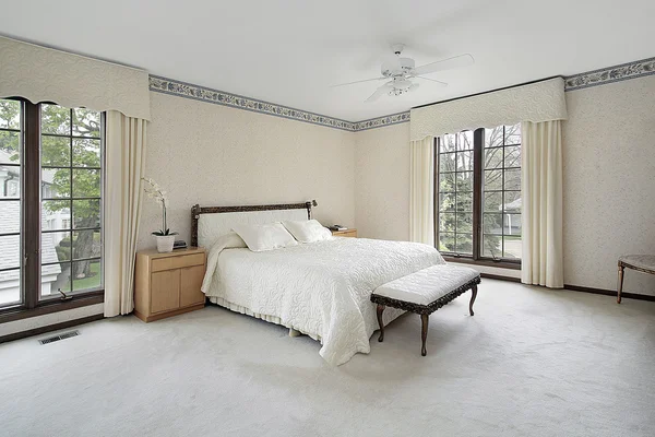 Master bedroom with wood trim windows — Stock Photo, Image