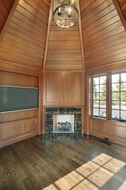 Library with wood paneled walls and fireplace clipart