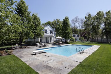 Swimming pool outside luxury home clipart