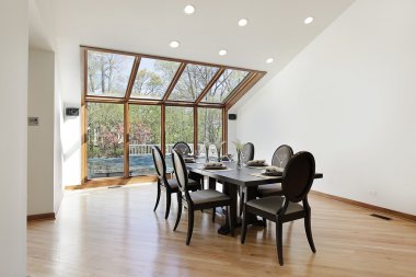 Dining room with wood skylights clipart