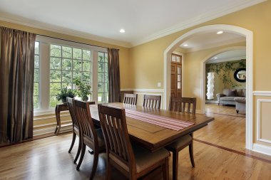 Dining room with yellow walls clipart