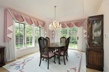 Dining room with pink draperies clipart