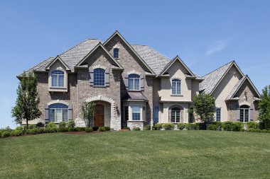 Large brick home with stone entry clipart