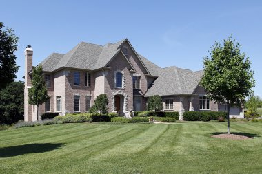 Brick home with arched entry clipart