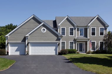 Home with gray siding and covered entry clipart