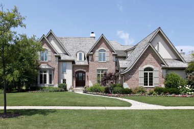 Brick home with cedar roof clipart