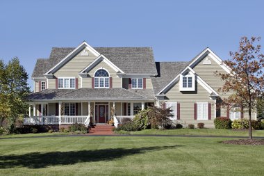 Large home with front porch and cedar roof clipart