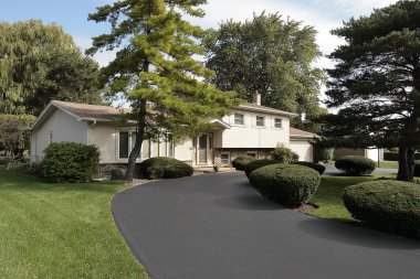 Home in suburbs with circular driveway clipart