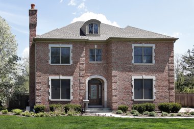 Brick home with arched entry clipart