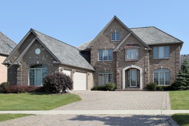 Brick home with arched entry clipart