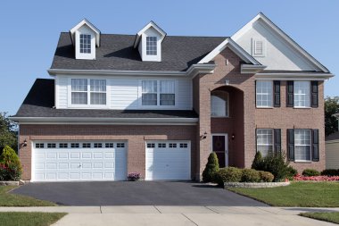 Brick home with arched entry clipart