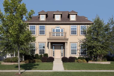 Salmon colored home with front balcony clipart