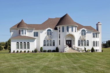 Luxury white home with front turret clipart