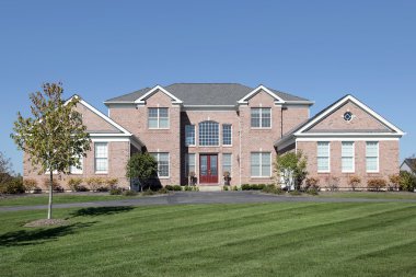 Large brick home with red door clipart