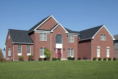 Large brick home with red door clipart