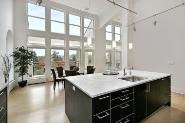 Modern kitchen with two story windows