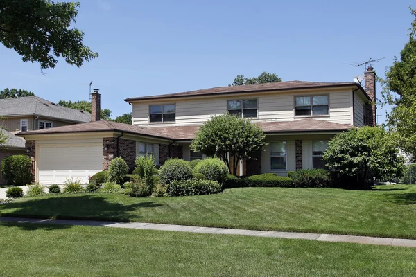 Brick home with shingled roof — Stock Photo, Image