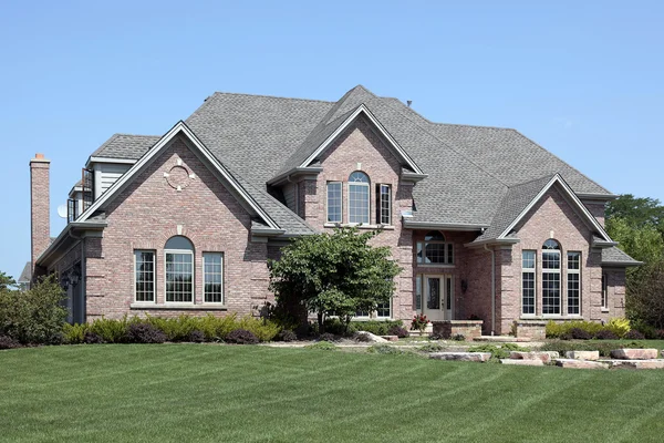 Luxury brick home with stone landscaping — Stock Photo, Image