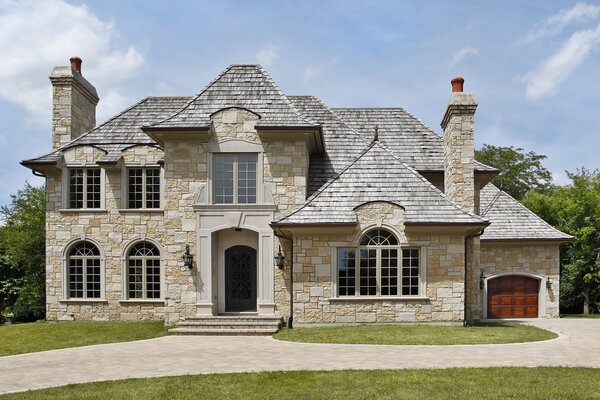 Luxury stone home with arched entryway
