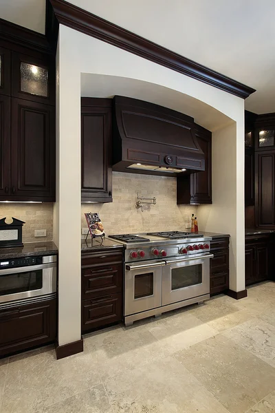 Kitchen with dark wood cabinetry — Stock Photo, Image