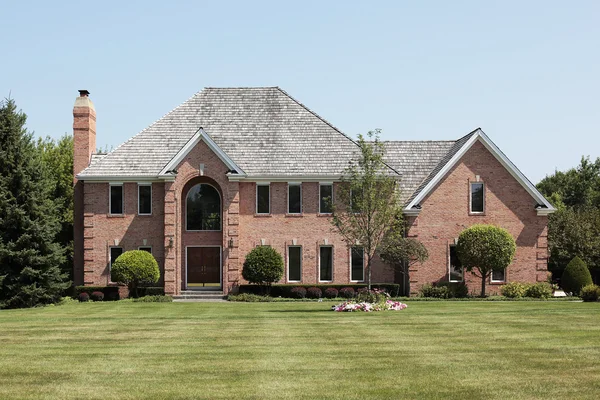 Luxury brick home with arched entry Royalty Free Stock Photos