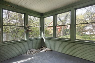 Green porch in old abandoned home clipart