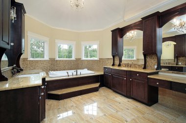 Master bath with dark wood cabinetry clipart