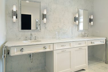 Upscale master bath with white cabinetry clipart