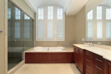 Master bath with wood paneled tub clipart