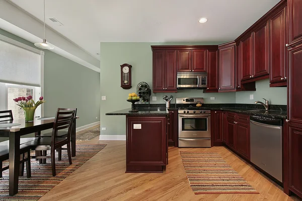 Kitchen with cherry wood cabinetry — Stock Photo, Image