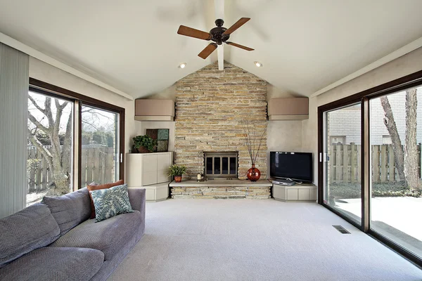 Family room with stone fireplace — Stock Photo, Image