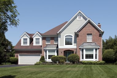 Suburban home with arched entry clipart