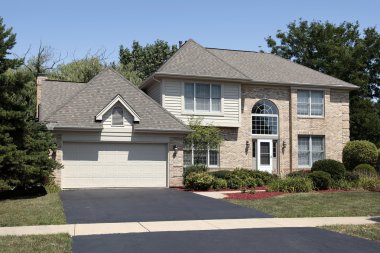 Suburban home with arched window clipart