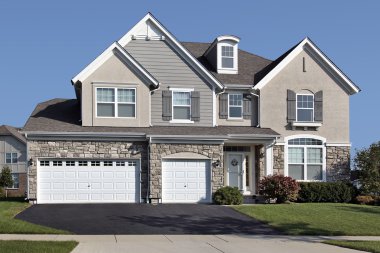 Home with three car stone garage clipart