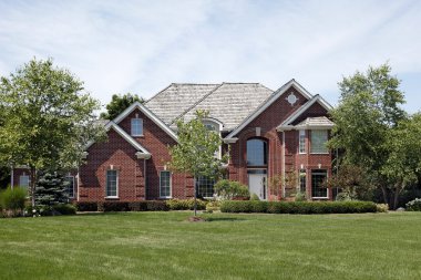 Large brick home in suburbs clipart