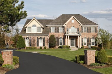 Luxury brick home in suburbs clipart