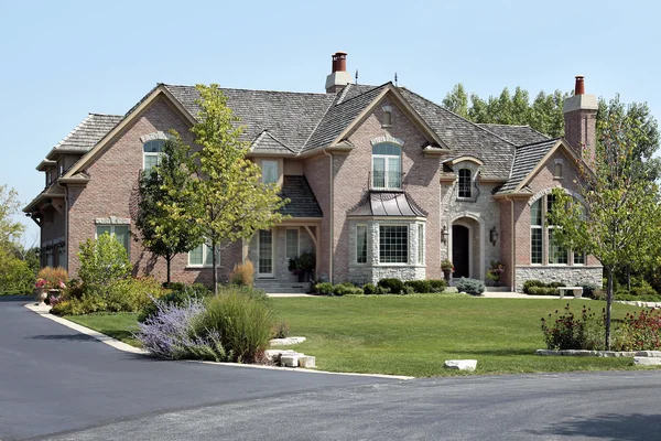 Luxury brick home with cedar shake roof — Stock Photo, Image