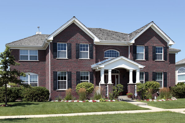 Large brick home with arched entry