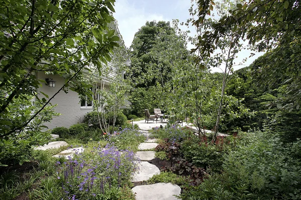 Stone patio with flowers and trees