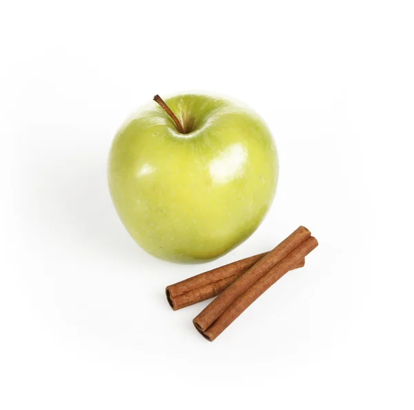 Green apple and cinnamon sticks — Stock Photo, Image
